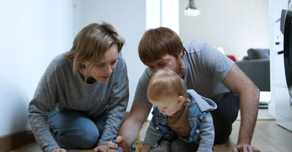 Parents and child drawing together indoors in a cozy Portuguese home.