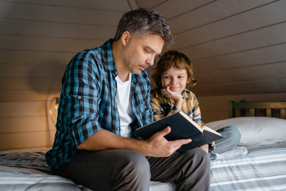 A father and son share a warm moment reading a book in a cozy attic bedroom.