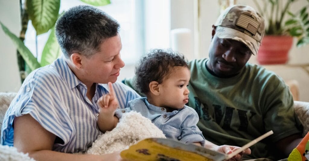 Diverse family enjoying a cozy reading session on the couch together.