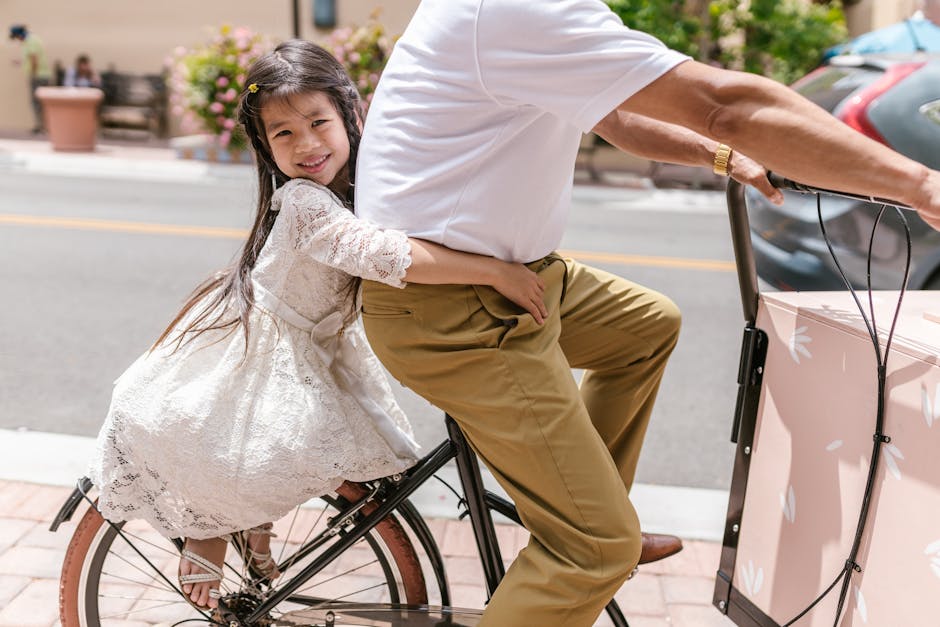 Young girl with long hair enjoys a bicycle ride on a sunny day outdoors.