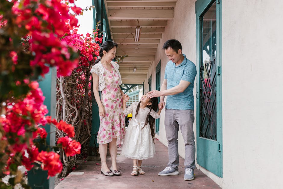 Asian family spending quality time outdoors, surrounded by vibrant flowers.