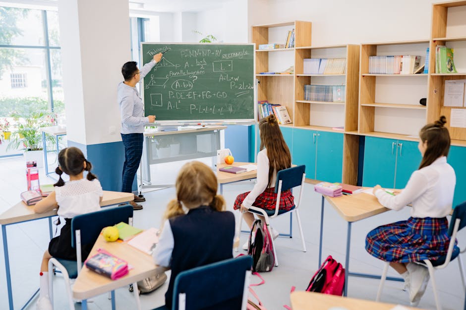 Children in a classroom focused on a math lesson with a teacher. Bright and educational atmosphere.