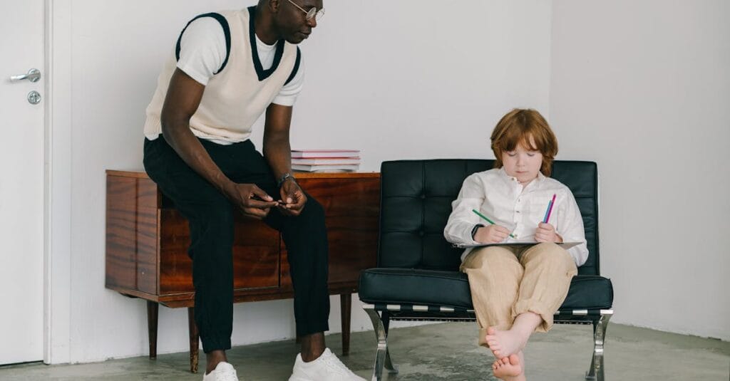 A child and adult engage in a therapy session with focus on drawing and communication.