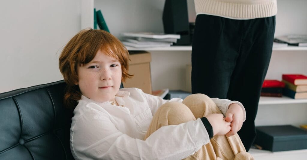A young boy in a therapy session sitting comfortably indoors, emphasizing child development.