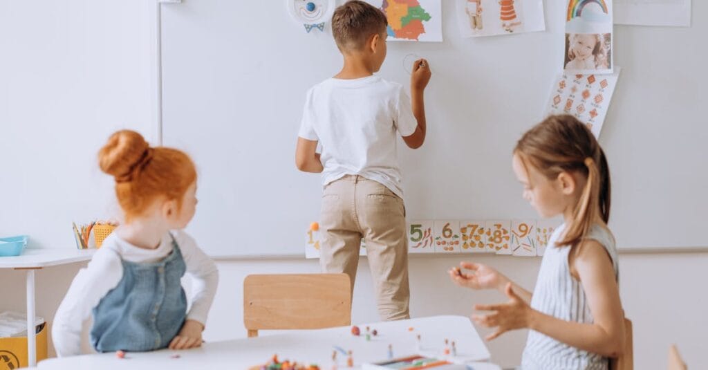 Young children engaging in creative activities in a vibrant classroom.
