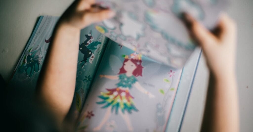 A child enjoying a colorful fairy tale book indoors, focusing on fantasy illustrations.