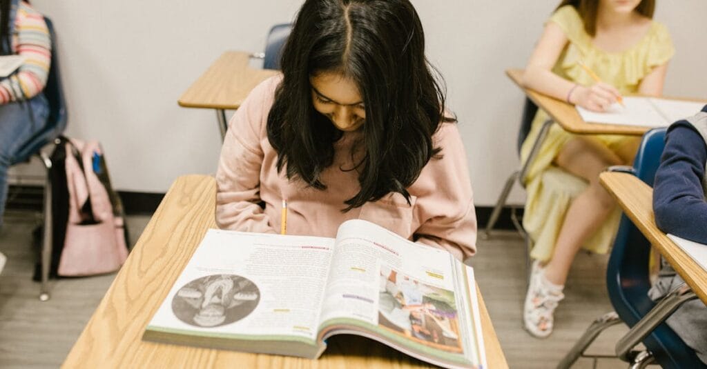 Students focused on their studies in a classroom, promoting education and learning.