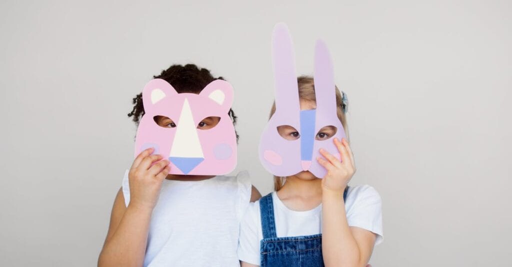 Two children wearing playful animal masks, showcasing creativity and imagination indoors.