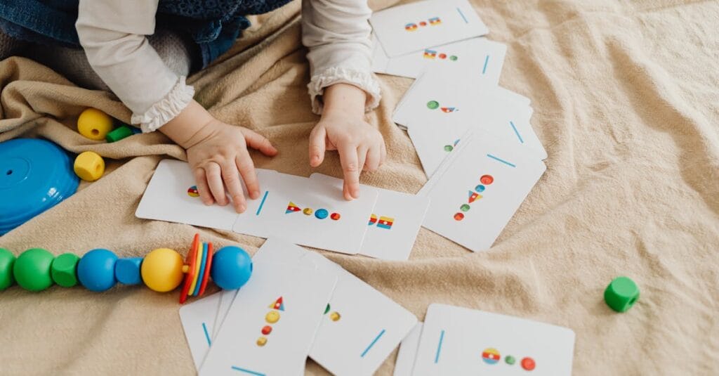 A child playing with educational cards and colorful toys, promoting cognitive skills and creativity.