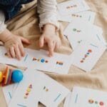 A child playing with educational cards and colorful toys, promoting cognitive skills and creativity.