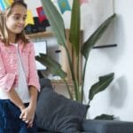 Cheerful children celebrating a birthday party indoors with colorful decorations in Portugal.