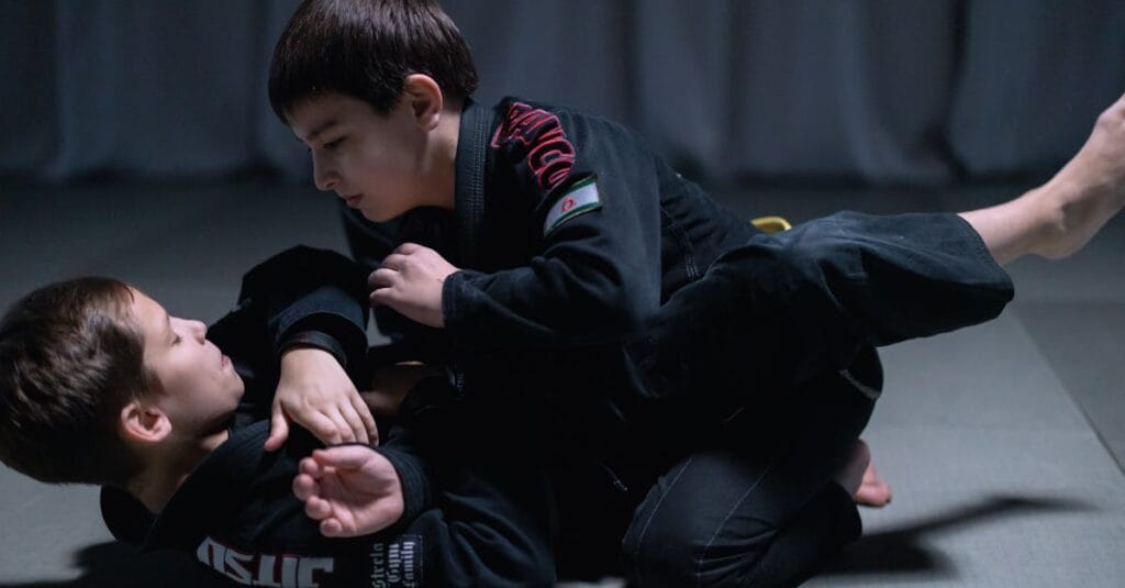Children engage in jiu jitsu sparring session wearing gis indoors. Martial arts training and practice.