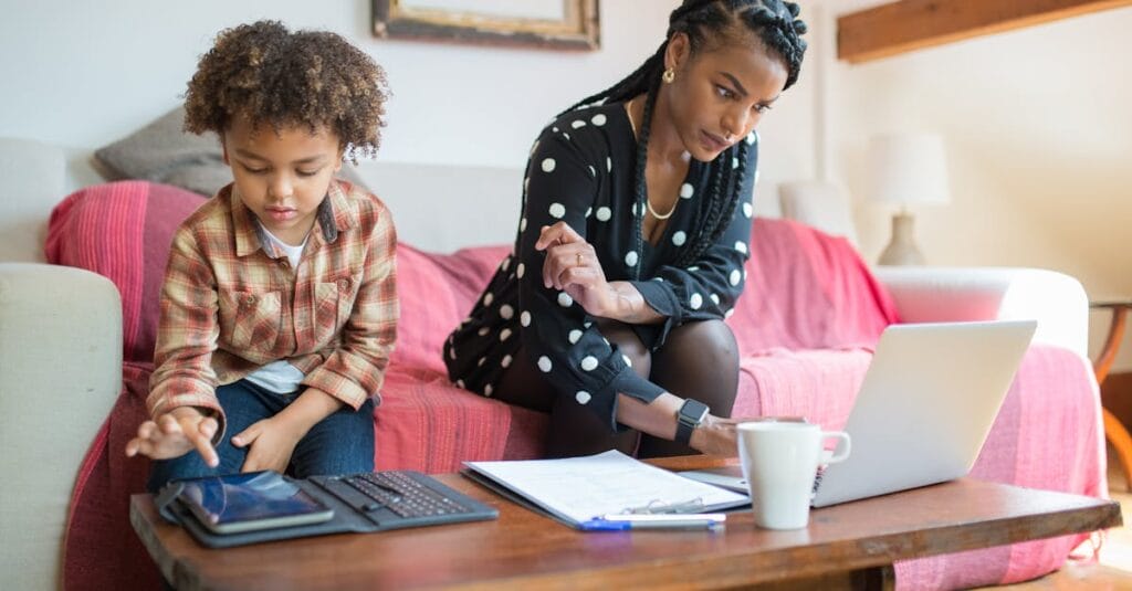A woman and her son using technology in a cozy living room setting.
