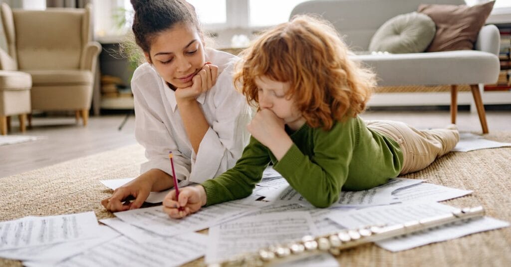 A mother and child study music sheets together at home with a flute. Warm and educational setting.