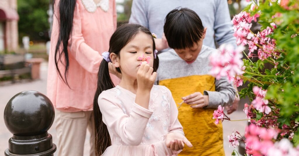 Happy children exploring flowers and nature during a family outing. Capturing joy and innocence.