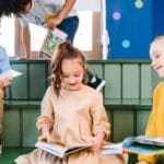 A group of children enjoying books in a vibrant indoor library setting.