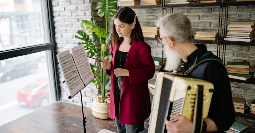 A student and teacher engaged in a music lesson with an accordion indoors.