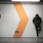 architecture, building, concrete, structure, wall, number, basement, people, guy, man, gray building, gray wall, gray numbers, number, number, number, number, number, people