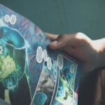 Close-up shot of hands holding a colorful superhero comic book in a sunlit room, depicting leisure reading.