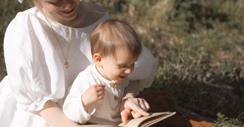 A mother and toddler enjoy reading together in a sunny outdoor setting.