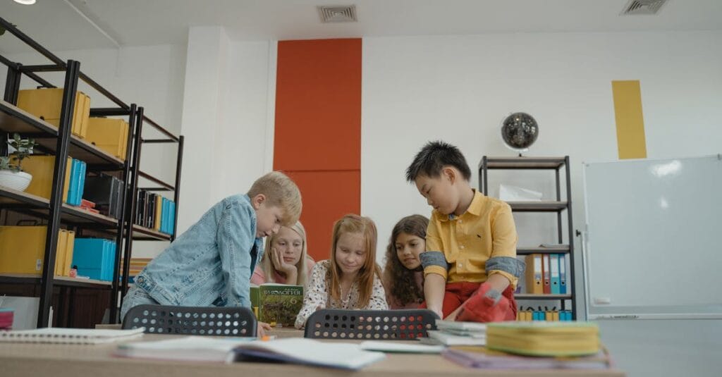 A group of diverse children reading together in a brightly lit classroom environment.