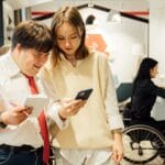 A diverse group in a coffee shop shows inclusivity and accessibility with attentive customer service.