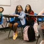 A diverse group of students attentively participating in a classroom setting.