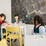 Diverse group of children in a classroom setting involved in conversation.