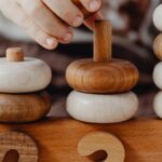 A child interacts with educational wooden number blocks, enhancing cognitive skills.
