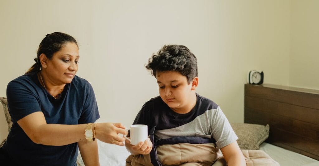 A nurturing mother hands her son a cup in a cozy morning setting.