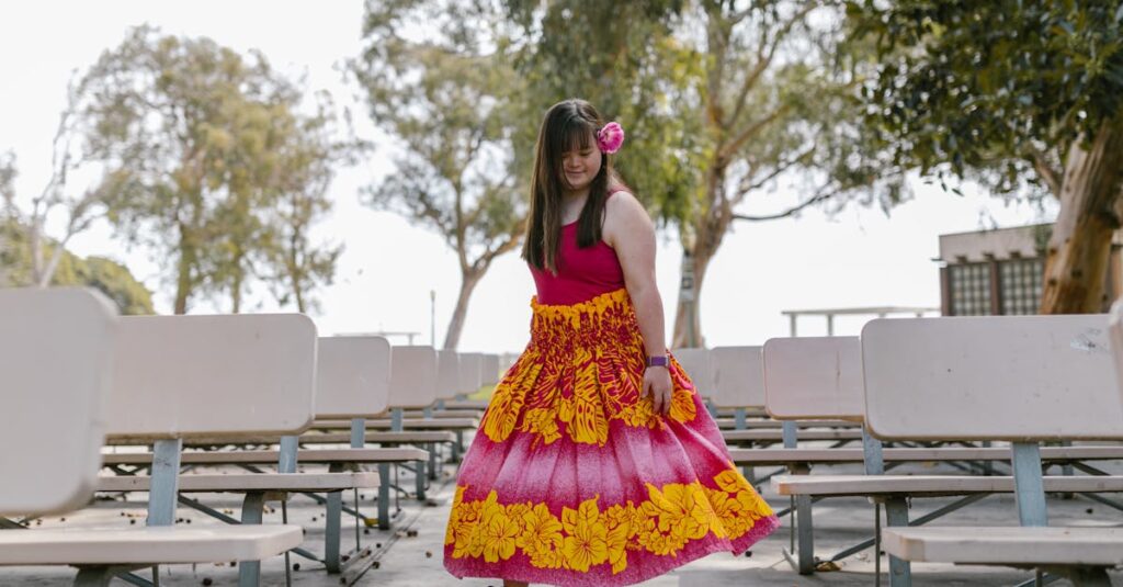 Young girl wearing a colorful dress with floral patterns in an outdoor park setting, enjoying a carefree moment.