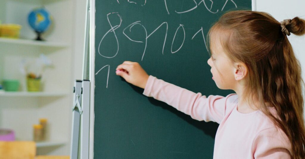 A girl engaging in educational learning by writing numbers on a chalkboard in a classroom.