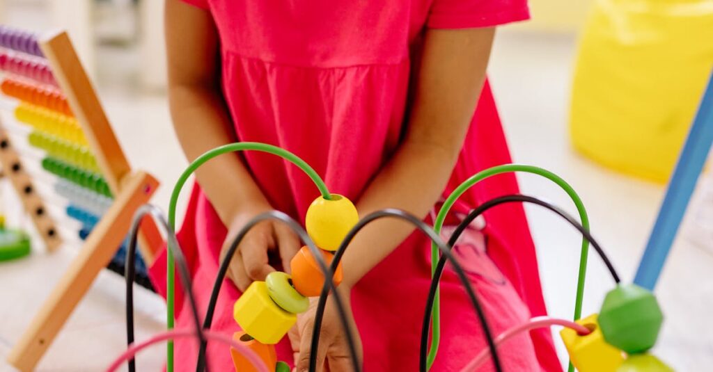 A young girl engages with colorful educational toys in a vibrant classroom setting.