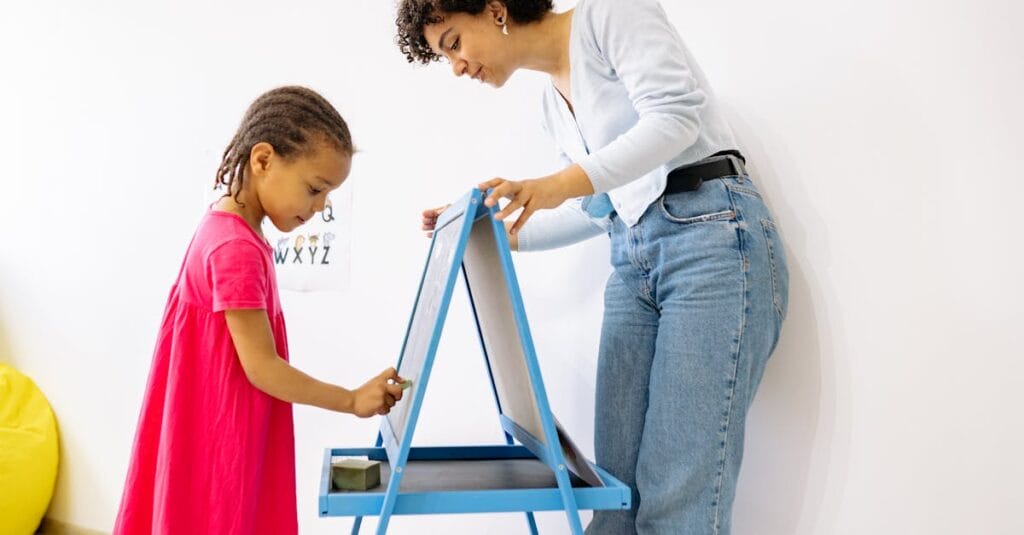 A child and teacher interact at a chalkboard, fostering education and creativity.