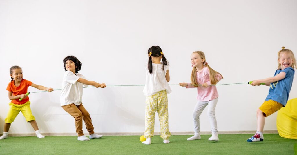 Happy children enjoying a tug of war game indoors, showcasing teamwork and fun.