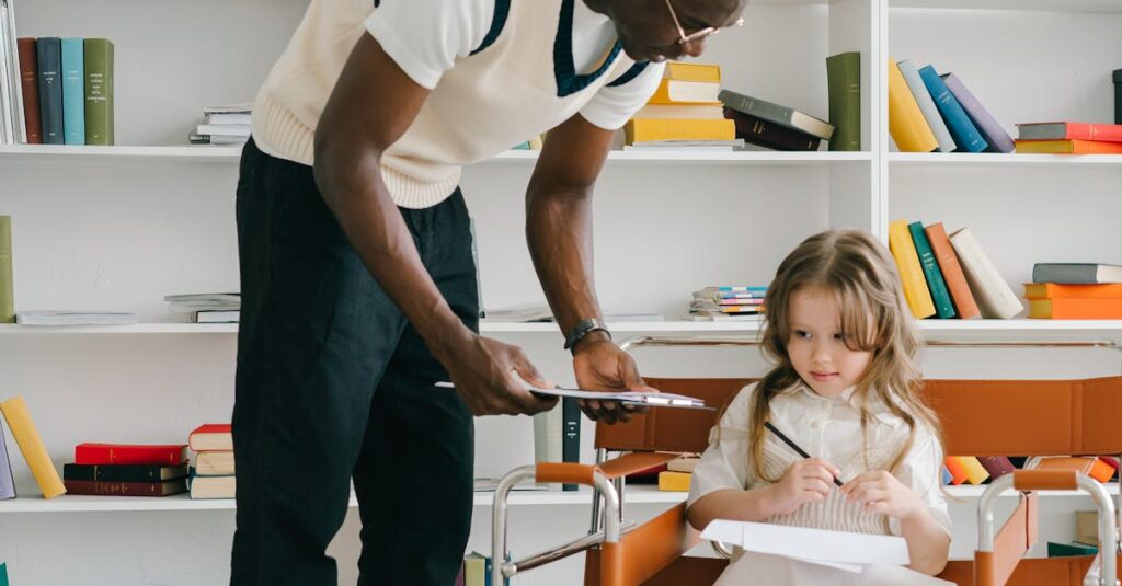 An adult male teacher assists a young girl in a classroom setting.