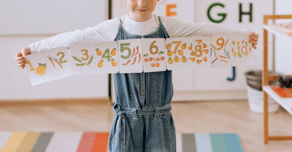 Young girl in a vibrant classroom holding a handmade number banner.