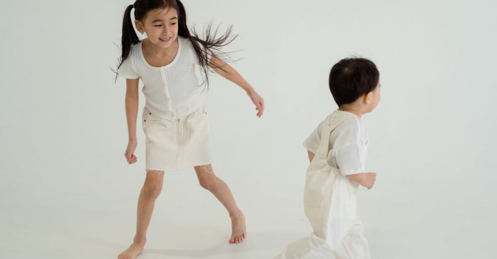 Joyful siblings playing together in a bright, minimalist studio setting.