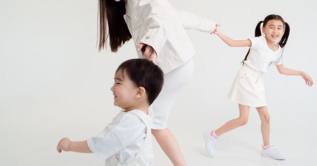 Joyful family of three playing and laughing in a bright studio setting.