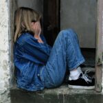 child is sitting, jeans, in the door, cry, sad, lonely, scared, hands on face, cry, scared, scared, scared, scared, scared