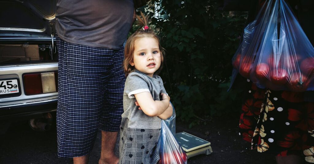 Charming little girl holds a bag of produce at an outdoor market, radiating innocence.