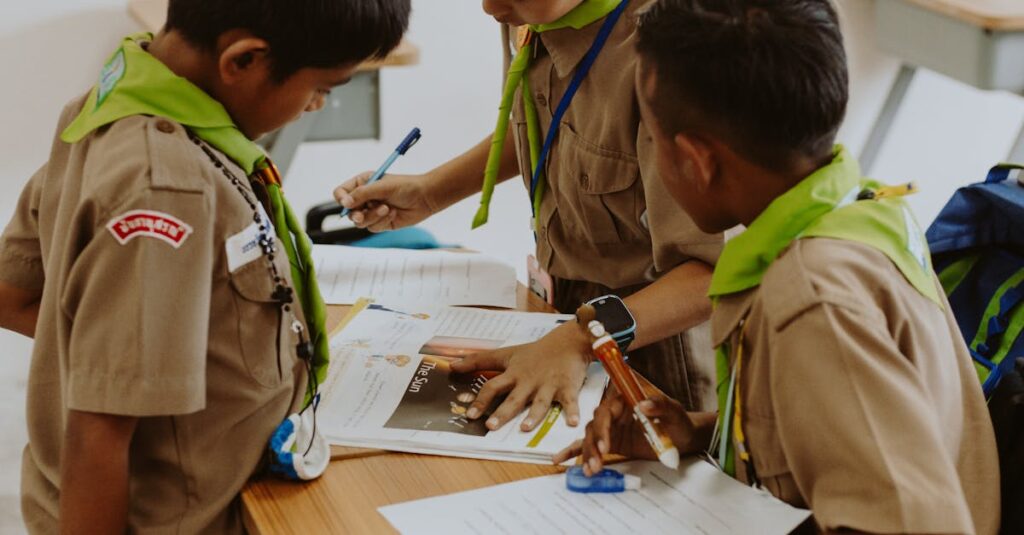 Children in school uniforms working together at a desk in a classroom.