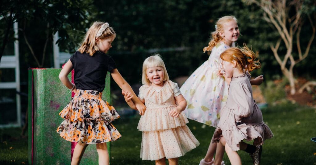 Four joyful children play in a garden, wearing colorful dresses and enjoying a sunny day.