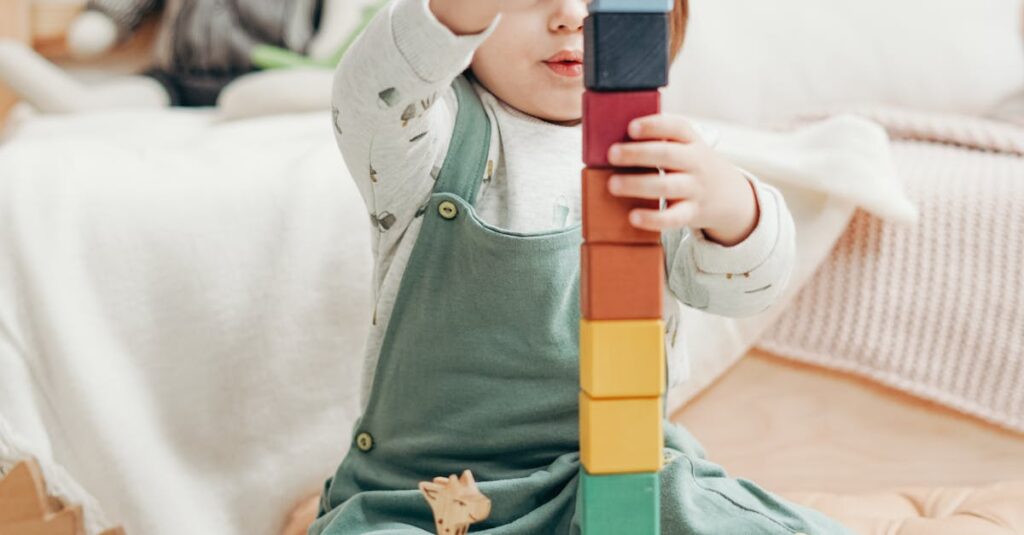 A cute child stacks colorful wooden blocks while playing indoors, surrounded by toys.