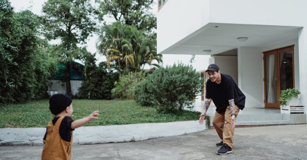 Father and child playing outside a modern detached house, surrounded by greenery.