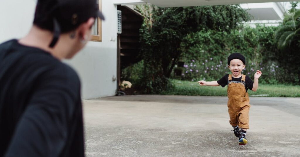 A young boy joyfully runs towards his father outdoors, capturing a playful family moment.