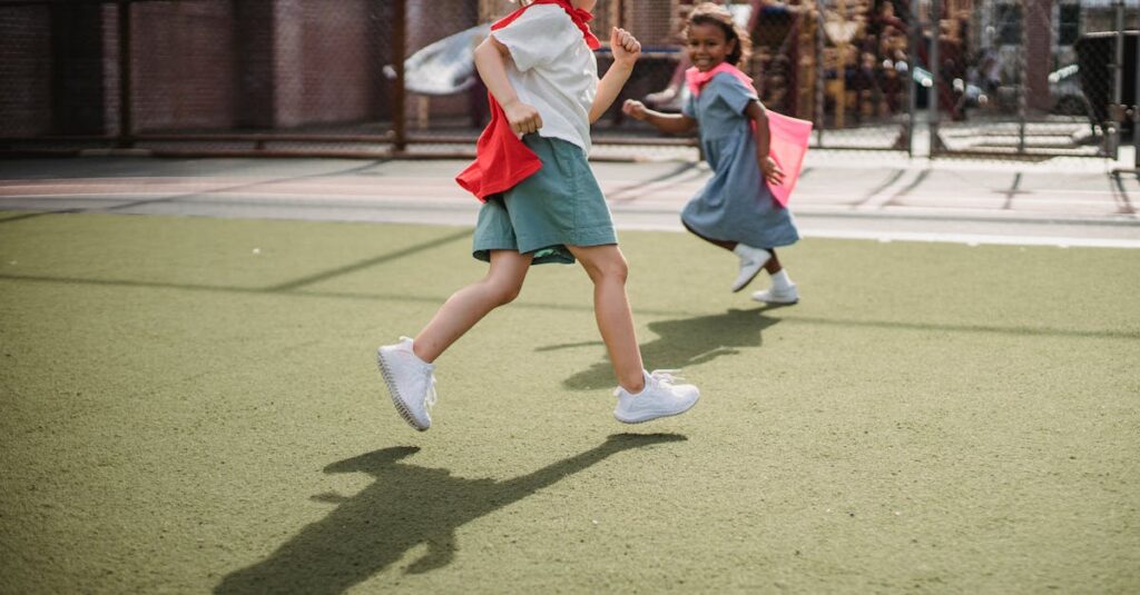 Two children happily running with capes, enjoying playtime on a sunny day outdoors.