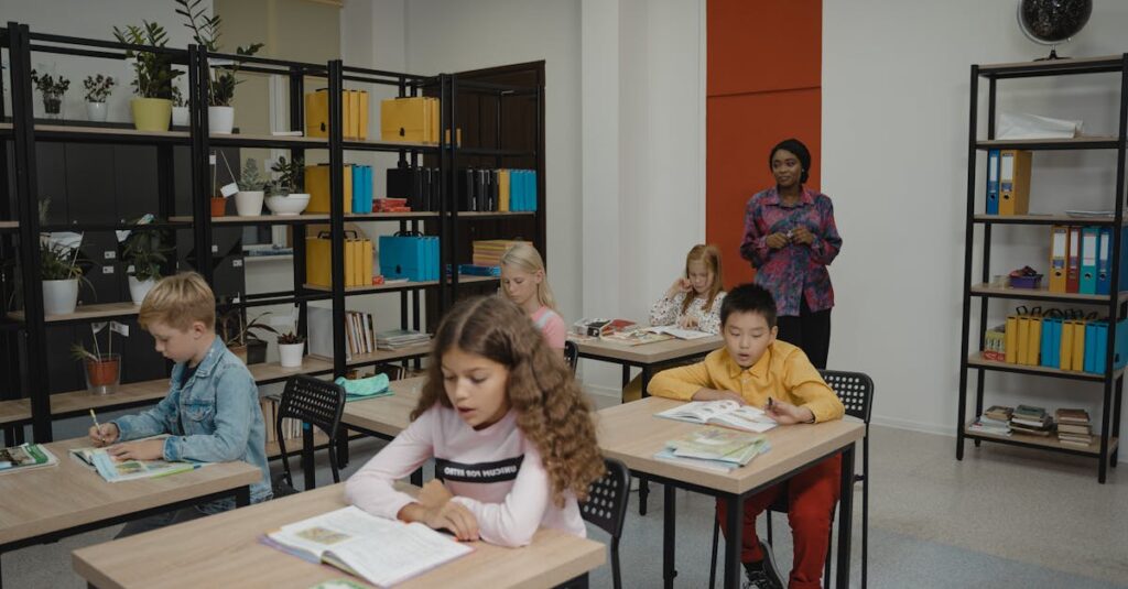 Elementary students focus on classwork with a teacher overseeing in a bright classroom.