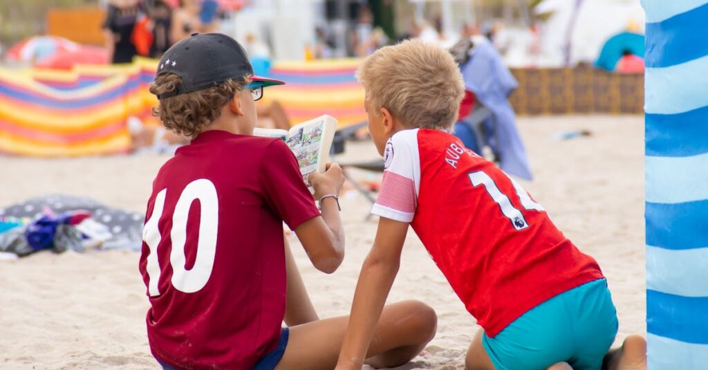 Two kids enjoying a book on Kolobrzeg beach, capturing a moment of summer relaxation.