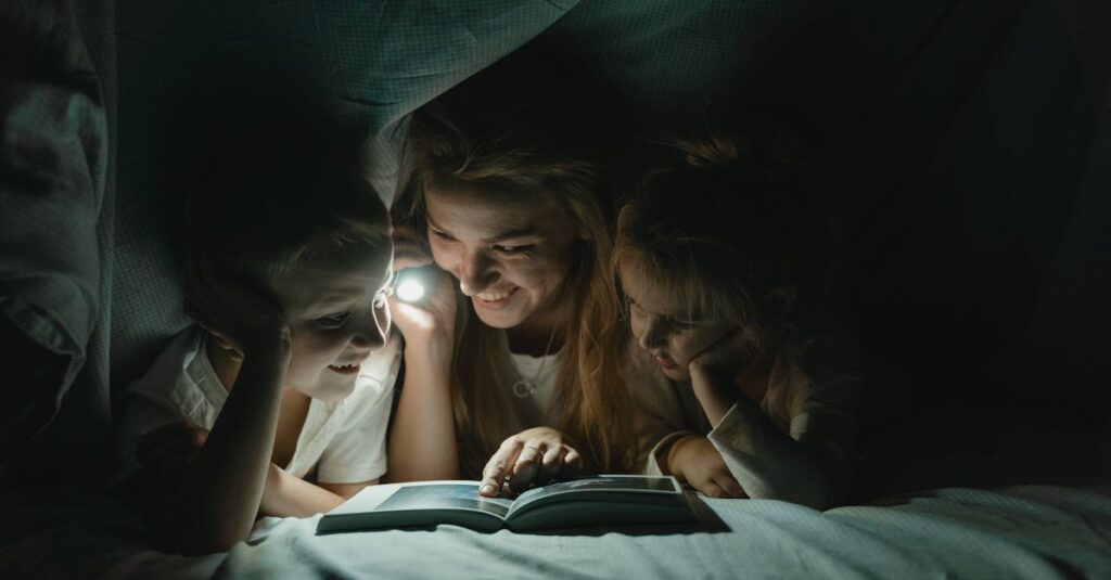 A mother reads a bedtime story to her children under the blanket with a flashlight, creating a warm, bonding moment.